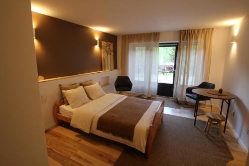 a bedroom with a bed and a table and chairs at Ostoja in Ojców