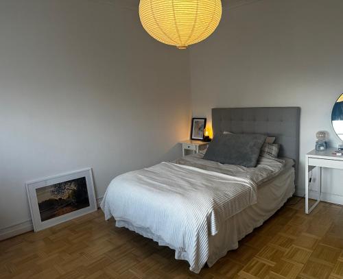 a bedroom with a bed and a chandelier at Våning Margareta in Kalmar