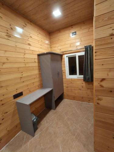 a small room with a bench in a log cabin at Mount Bliss Resort in Mhasla