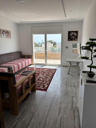 a living room with a couch and a table at Appartement vue mer 200m in Rejiche