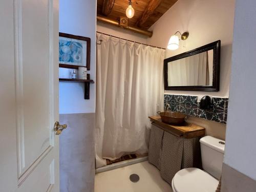a bathroom with a sink and a toilet and a mirror at Apartamento Tana by SIERRA VIVA in Puerto-Gil