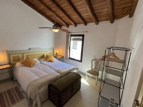 a bedroom with a large bed and a ladder at Apartamento Tana by SIERRA VIVA in Puerto-Gil