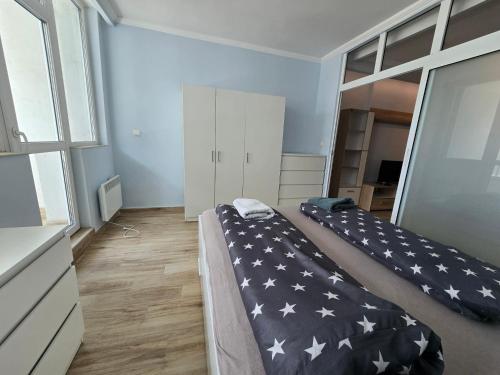 a bedroom with two beds with a blanket with stars at GOLD Residence in Sofia
