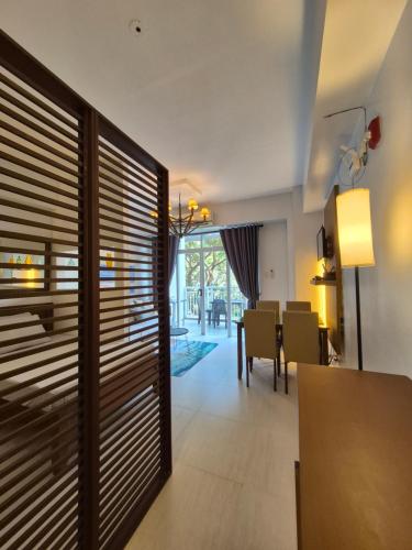a dining room with wooden blinds and a dining table at Tropical Escape at Pico De Loro in Nasugbu