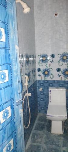 a bathroom with a shower with a toilet in it at gururesidency in Tiruvannāmalai