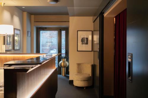 a hotel room with a bar and a chair at Speronari Suites in Milan