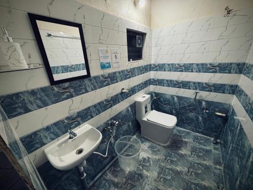 a bathroom with a sink and a toilet at Deodar Commune in Visakhapatnam
