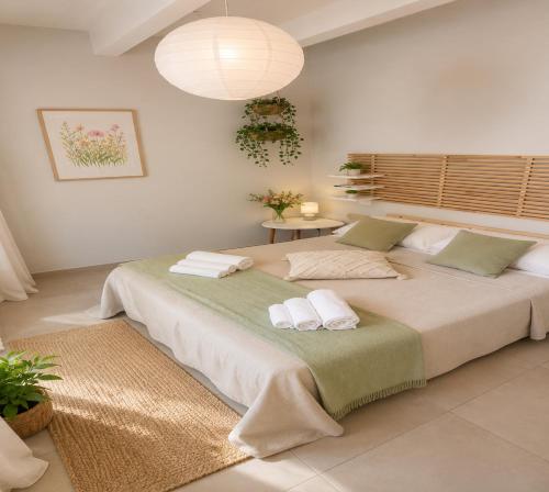 a bedroom with a large bed with towels on it at Maison La Reggia in Caserta