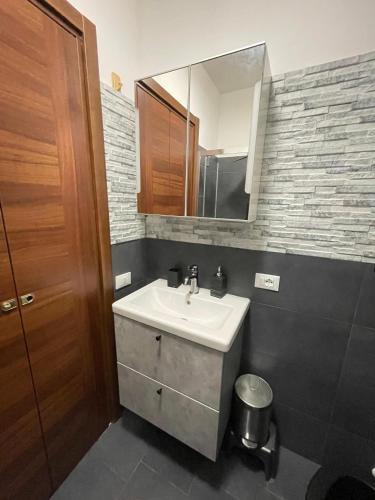 a bathroom with a sink and a mirror at Nerone's House Villa with garden near the sea, ideal for family in Anzio