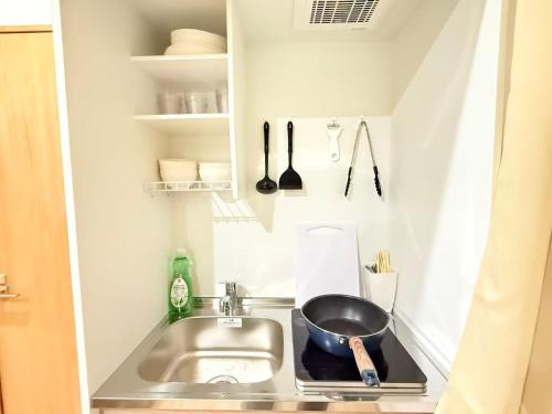 a kitchen with a sink and a bowl on a counter at クリスタルSky tree Hotel in Tokyo