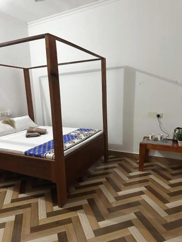 a bedroom with a bed and a wooden floor at Kipe House Nungwi in Nungwi