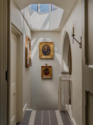 a hallway with paintings and pictures on the wall at The Green in Wingfield