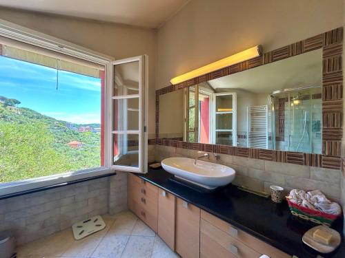 a bathroom with a sink and a large window at COGO, Premium Private Villa Vista Mare in Cogorno