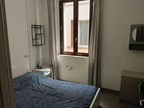 a bedroom with a bed and a window at Console Camprini Estates - Faenza Apartments 2 in Faenza