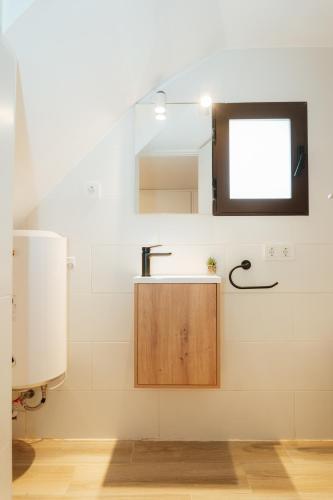 a bathroom with a sink and a window at Trepat Harbor's Light in Villajoyosa