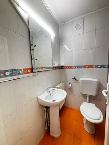 a bathroom with a sink and a toilet and a mirror at Casa Scriitorilor in Olimp