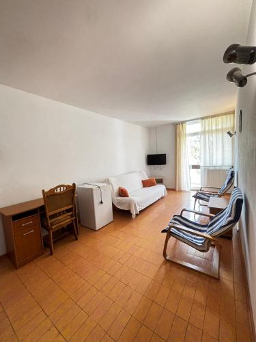 a living room with a couch and a table and chairs at Casa Scriitorilor in Olimp