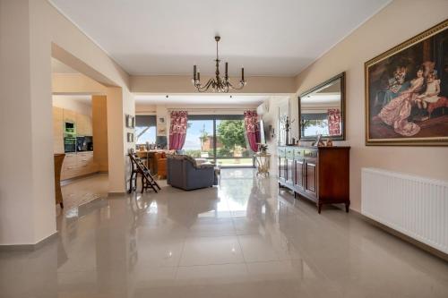a large living room with a large painting on the wall at Celeste Sea View Home with Jacuzzi and BBQ in Psalidi