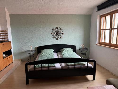 a bedroom with a black bed in a room at Ferienwohnung Lechner in Treffelstein