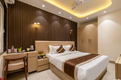 a bedroom with a large bed and a desk at Hotel Silver Star in Greater Noida