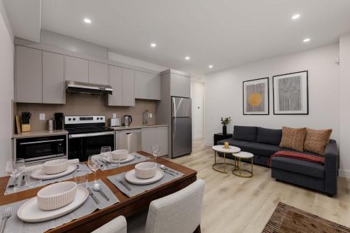 a kitchen and living room with a couch and a table at Newly Built Suite-West Coquitlam in Coquitlam