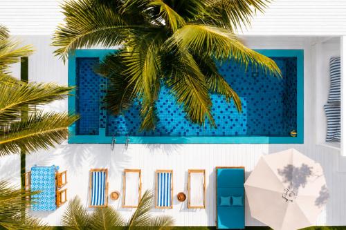 a building with a swimming pool next to a palm tree at Lanta Secret House in Ko Lanta