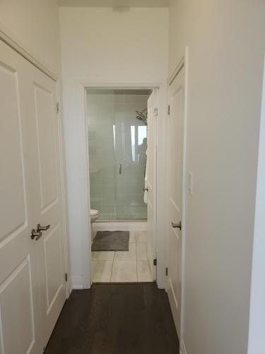 a bathroom with a walk in shower and a toilet at Lake breeze water view in Bowmanville