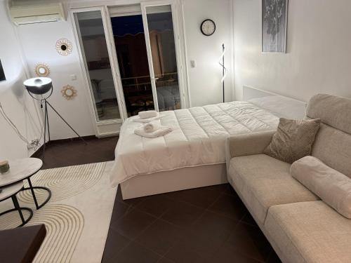 a living room with a bed and a couch at Paula suite avec terrasse-Croisette, Plage Festival Palais in Cannes
