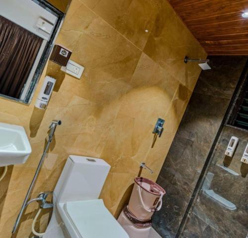 a bathroom with a toilet and a sink at Hotel Grand Heritage Badami in Badami