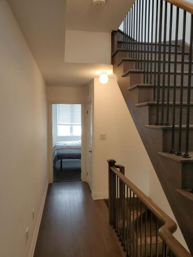 a hallway with a staircase in a house at Lake breeze water view in Bowmanville
