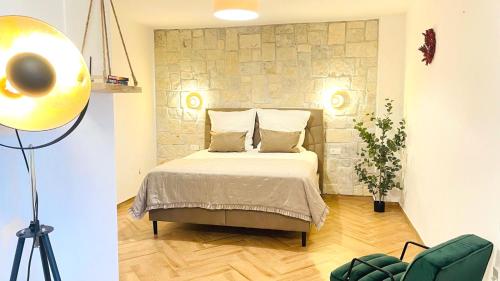 a bedroom with a bed in a room at Stonehouse-Pag in Povljana