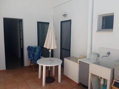 a room with a table with a lamp on it at Via Piave 14 in Santa Cesarea Terme