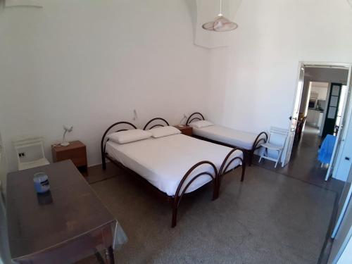 a bedroom with a bed and a table in it at Via Piave 14 in Santa Cesarea Terme