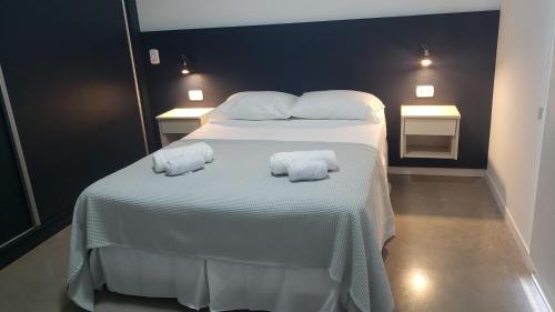 a bedroom with a bed with two towels on it at Departamentos Felice in Santa Rosa