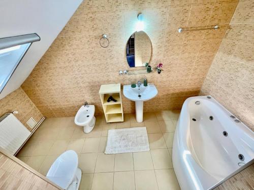 a bathroom with a tub and a sink at Pensiunea Gerard 2 Mai Camere Moderne cu baie privata, la 250 M de plaja ,Foisor, Parcare & WIfi Gratuit in 2 Mai