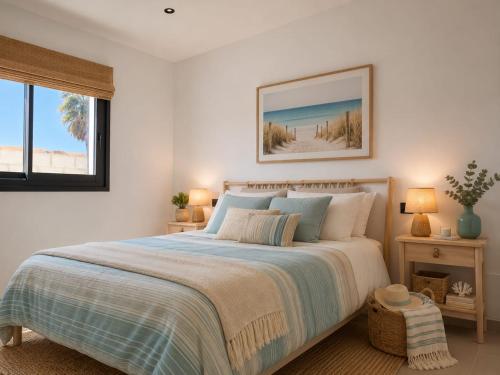 a white bedroom with a large bed and a window at Bungalows y Glamping Medina Sidonia in Medina Sidonia