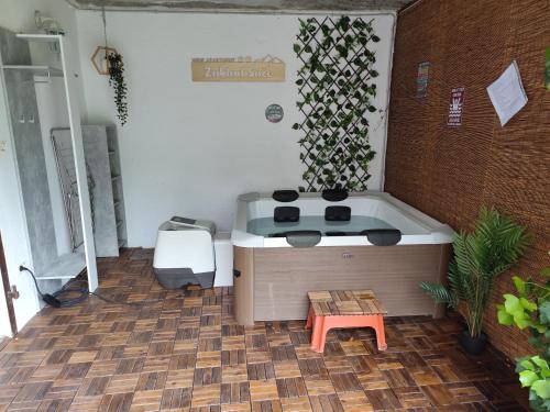 a small bath tub in a room with a table at Apartment Zaklad Soče with hot tub and free parking in Bovec