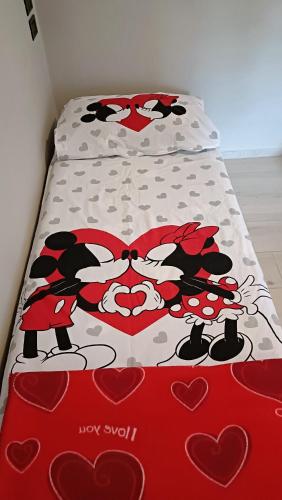 a bed with a hello kitty comforter on it at La Casetta in Ameno