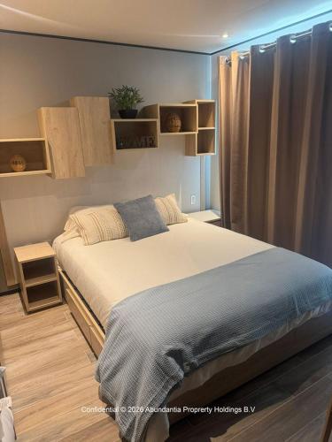 a bedroom with a large bed in a room at studio to Maho in Cupecoy
