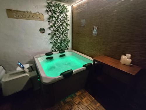 a bath tub with a green water in a bathroom at Apartment Zaklad Soče with hot tub and free parking in Bovec