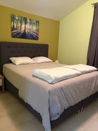 a bedroom with a large bed with white sheets at Villa Luna Maris in Starigrad