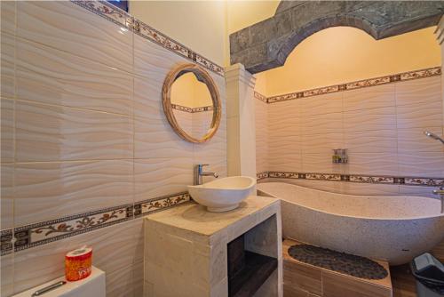 a bathroom with a sink and a bath tub at Murni’s House in Lovina