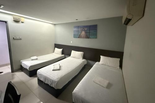 a hotel room with two beds at Tiong Nam Hotel Near Pasir Gudang in Pasir Gudang