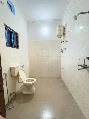 a bathroom with a toilet and a shower at The pink villa in Jaipur