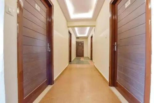 an empty corridor with two doors and a hallway sidx sidx at FabHotel Jaipur Classic - Vaishali Nagar in Jāmb