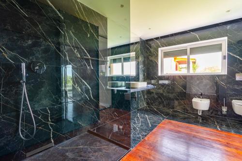 a bathroom with two sinks and a shower at Kuća za odmor ANTON in Blato