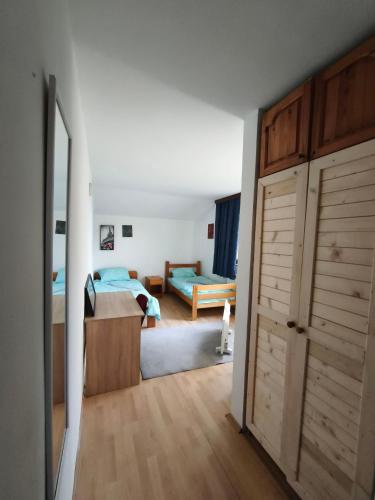 a room with a bedroom with a bed and a closet at Hideout Guest House in Travnik
