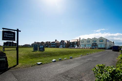 a street sign on the side of a road with houses at Beach House Hotel in Seahouses