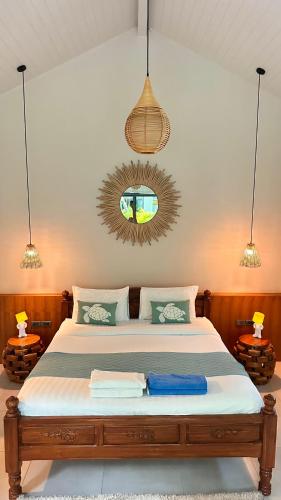 a bedroom with a large bed and a mirror at Crystal Bungalow DELUXE in Ko Phangan