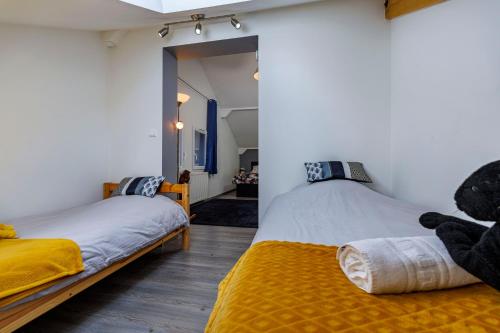 a bedroom with two beds with teddy bears on them at Au doux passage in Les Rousses